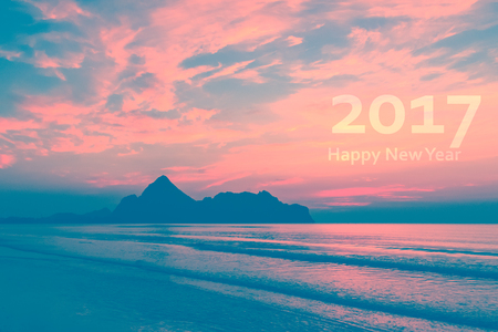 Happy New Year 2017. Natural scene beach and sea at sunrise time. Retro vintage filter effect.