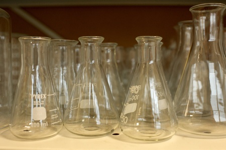 Erlenmeyer flask glass cylinders on a shelf in a comprehensive school chemistry labの写真素材