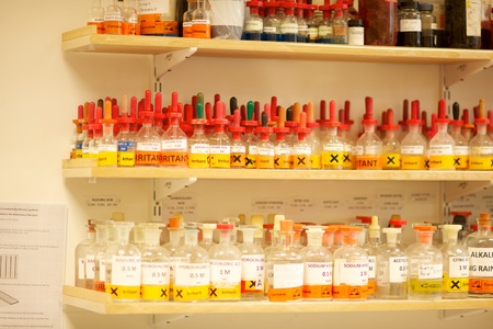 Bottles of chemcicals on shelves in a Science laboratory including Potassium Iodide, Potassium Chloride, Potassium bromide, Sodium nitrate, Chemicalsの写真素材