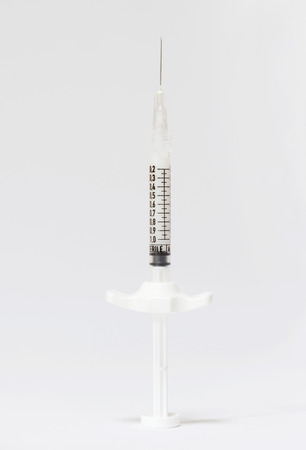 Sterile medical syringe on a white backgroundの写真素材