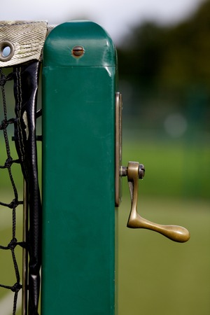 Tennis  court net handle on green post.の写真素材