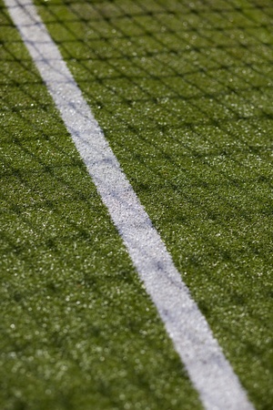 Green tennis court with net and white line markingの写真素材