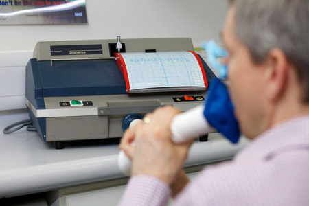 A spirometer is an apparatus for measuring the volume of air inspired and expired by the lungs. A spirometer measures ventilation, the movement of air into and out of the lungs.の写真素材