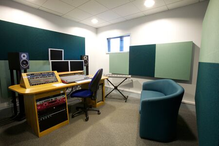 Sound studio with speakers, monitors, a sound board and sound absorbers on the walls,の写真素材