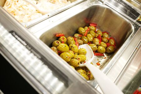 stainless steel self service container with green olivesの写真素材