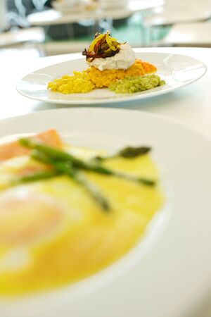 Fine dining food and drink being prepared and displayed in classic white crockery in a kitchen environment,の写真素材