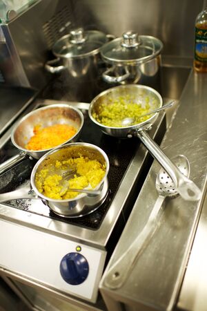 Fine dining food and drink being prepared and displayed in classic white crockery in a kitchen environment,の写真素材