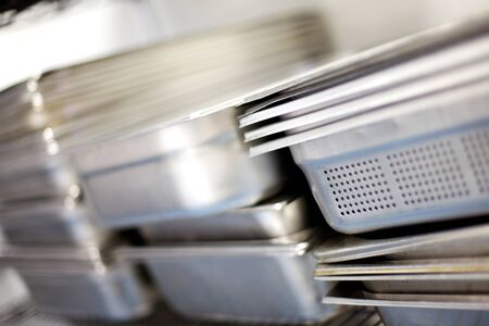 Metal serving trays stacked together for use in a commercial kitchen,の写真素材