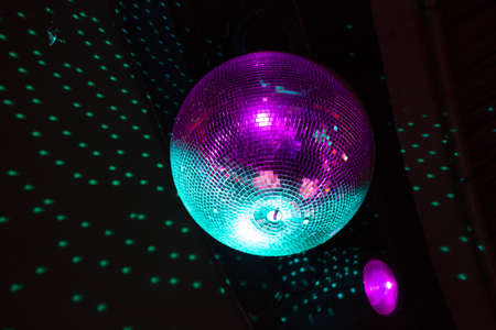 Close up of a disco ball reflection light onto a black ceiling,の写真素材