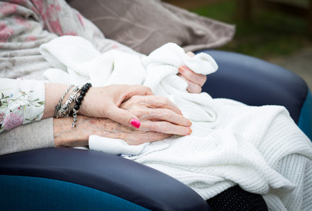 Holding the hand of an elderly relative