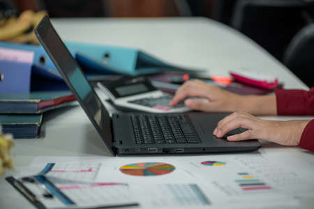Business girl working in office and using laptop. Business financial accounting calculate, Graph analysis, business planning.の写真素材