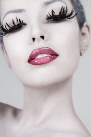 Young beautiful fashion model with creative makeup close-up portraitの写真素材