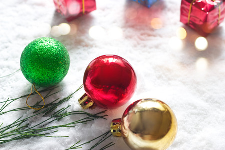 Christmas ball with green pine and gift boxs on snow morning backgroundの写真素材