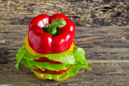 colorful sweet pepper slices decoration on wooden background, blank textの写真素材