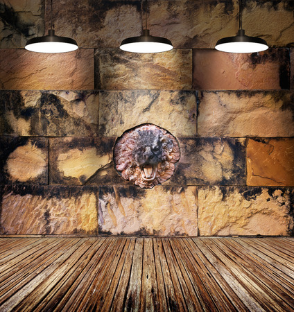 colorful stained lion stone and old brick wall, lamp light on wooden floorの写真素材
