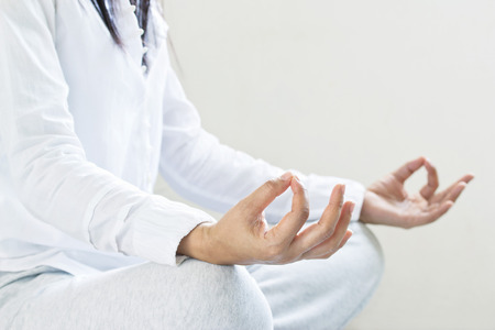 woman meditating of purity energy insight on gray background, selective focusの写真素材