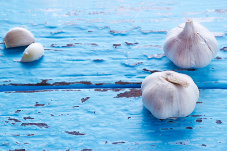 vintage pastel color tone style of garlic on blue vibrant color wooden background, vibrant and colorful conceptの写真素材