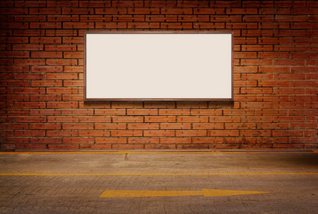 light box or white board on brick grunge wall and street floor backgroundの写真素材
