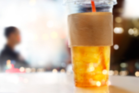 abstract lemon ice tea in plastic glasses on restaurant background, soft and blur conceptの写真素材