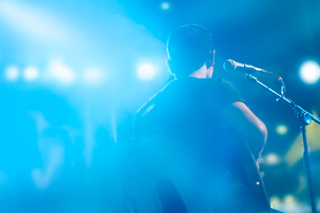 Guitarist on stage for background, blank text, soft focus and blur conceptの写真素材
