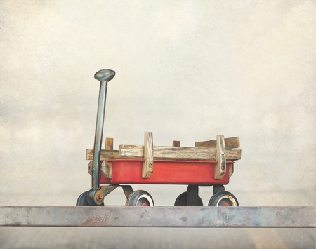 Red pull trolley toys, old rusty wagon, Vintage color tone on paper grainの写真素材
