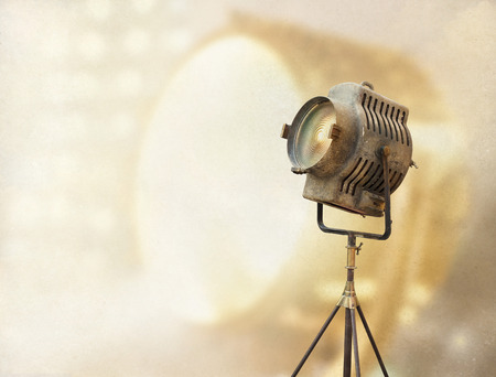 Vintage Movie Light on a stand and papper grain vintage color tone background, blank text