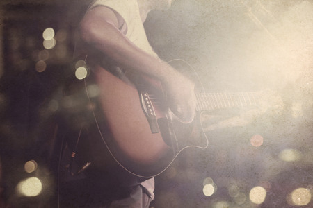 Guitarist on stage grunge background, vintage and retro color tone style, soft and blur conceptの写真素材