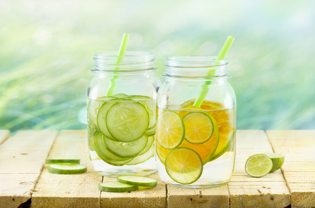 Infused detox water, Vintage and pastel color tone, Detox diet lemon and cucumber on wooden nature backgroundの写真素材