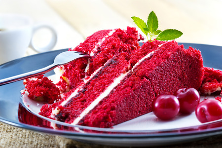 Cherry cheesecake and slices of raw cherry with mint, delicious dessert with coffee, soft focusの写真素材