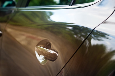 car door handle of a sport car on the street, soft focus, selective focus on handleの写真素材