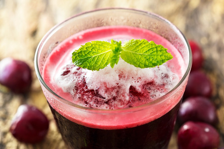 vibrant smoothie cherry on wooden backgroundの写真素材