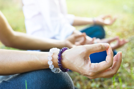 women meditating outdoors in green park nature backgroundの写真素材