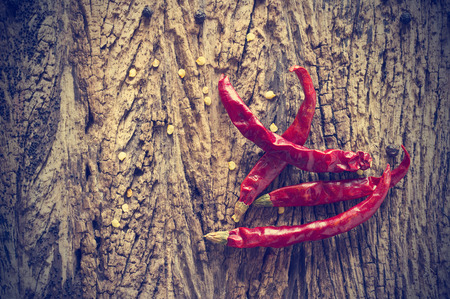 Dried red chili peppers on old wooden background,Vintage color toneの写真素材