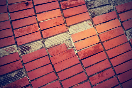 broken red tiles on old cement floorの写真素材