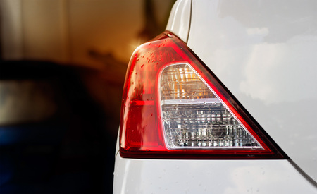 backights of white car after the rain on car parkingの写真素材