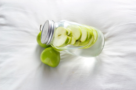 Detox diet fresh green apples soak in water of the jarの写真素材