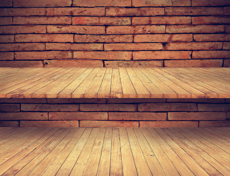 wooden floor and shelves on old brick wall texture for backgroundの写真素材
