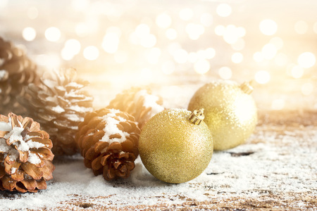 Gold christmas ornament pine cones on woodenの写真素材