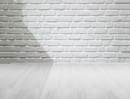 white brick wall and wooden floor with lighting and shadow, black and whiteの写真素材