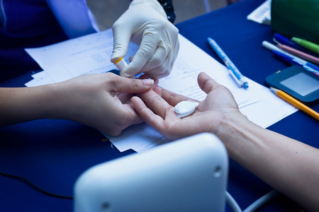 Doctor takes blood on the analysis from woman, Health care conceptの写真素材