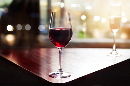 wine glass in entertaining room among sunset window backgroundの写真素材