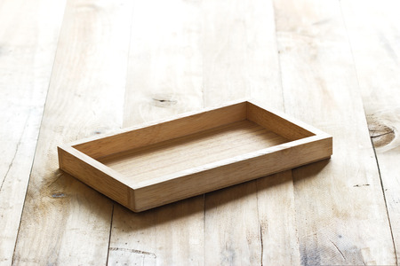 empty wooden tray on plank wooden backgroundの写真素材