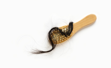 woman losing hair on hairbrush on white background, blank textの写真素材