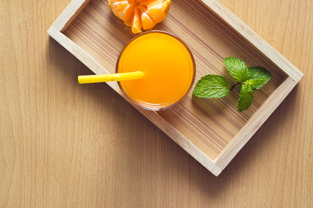 Orange and orange juice with mint in tray wood on wooden background, Top viewの写真素材