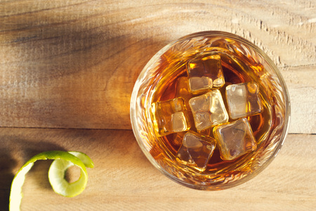 Glass of whiskey with ice on wooden background, Top viewの写真素材