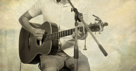 guitarist on stage on paper texture background, blur and grunge filtered effect imagesの写真素材