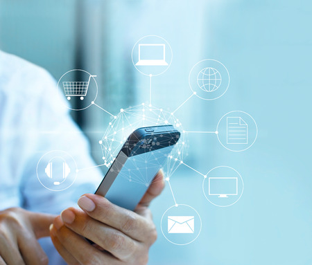 Man using mobile payment, holding circle global and icon customer network connection, Omni Channel or Multi channelの写真素材