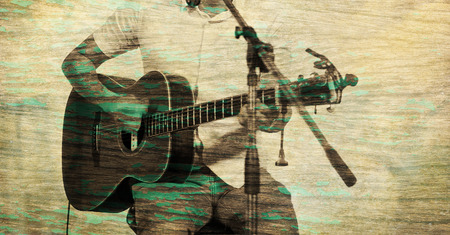 guitarist on stage on wooden and paper texture background, blur and grunge effect conceptの写真素材