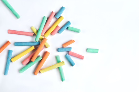 colorful chalk scattered on a white background