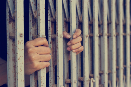 hands of woman who was imprisonedの写真素材